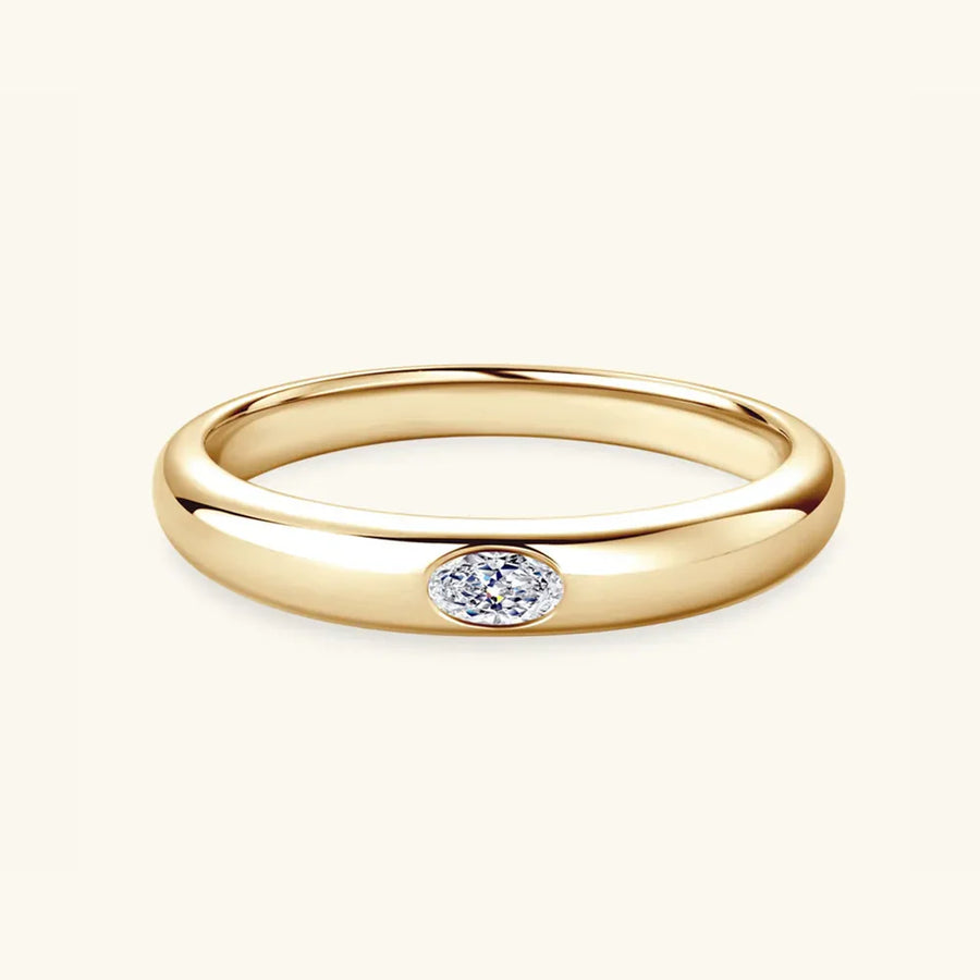 Gold band ring with oval moissanite stone