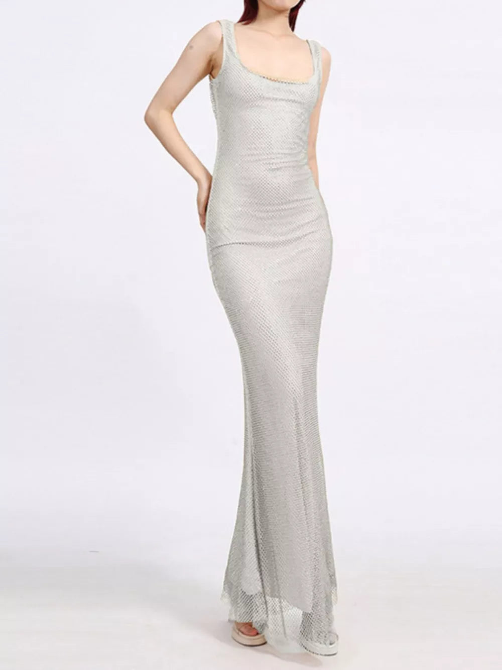 Silver mesh maxi dress with square neckline and sleeveless cut, floor length.