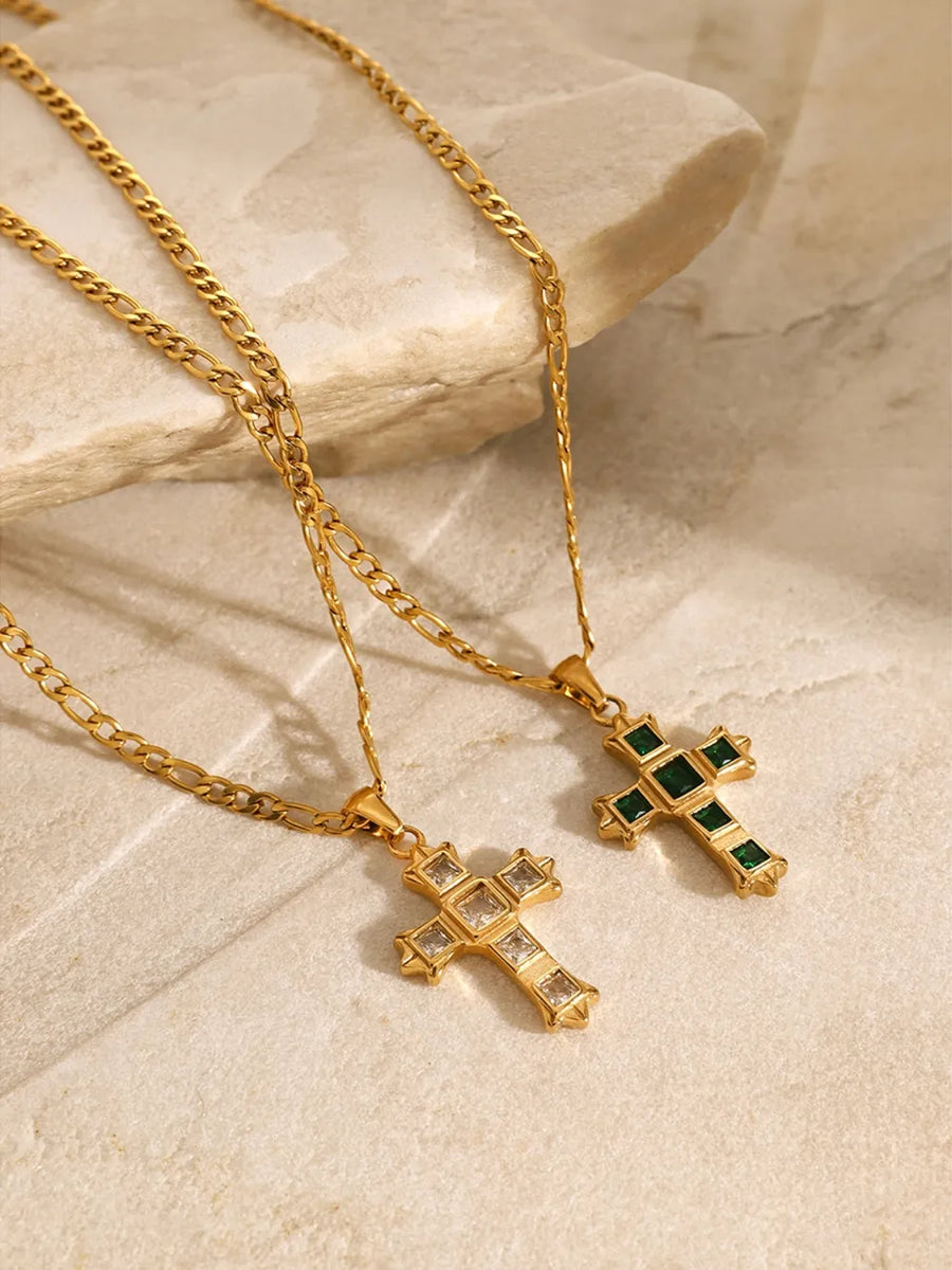 Gold cross pendant necklaces with green and white zirconia stones.