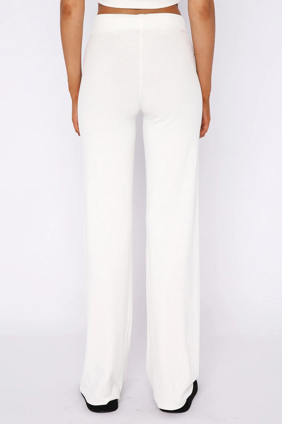 White ribbed wide leg pants with a high waist, shown from the back.