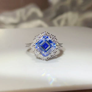 ring in sapphire blue featuring halo setting and square halo fit