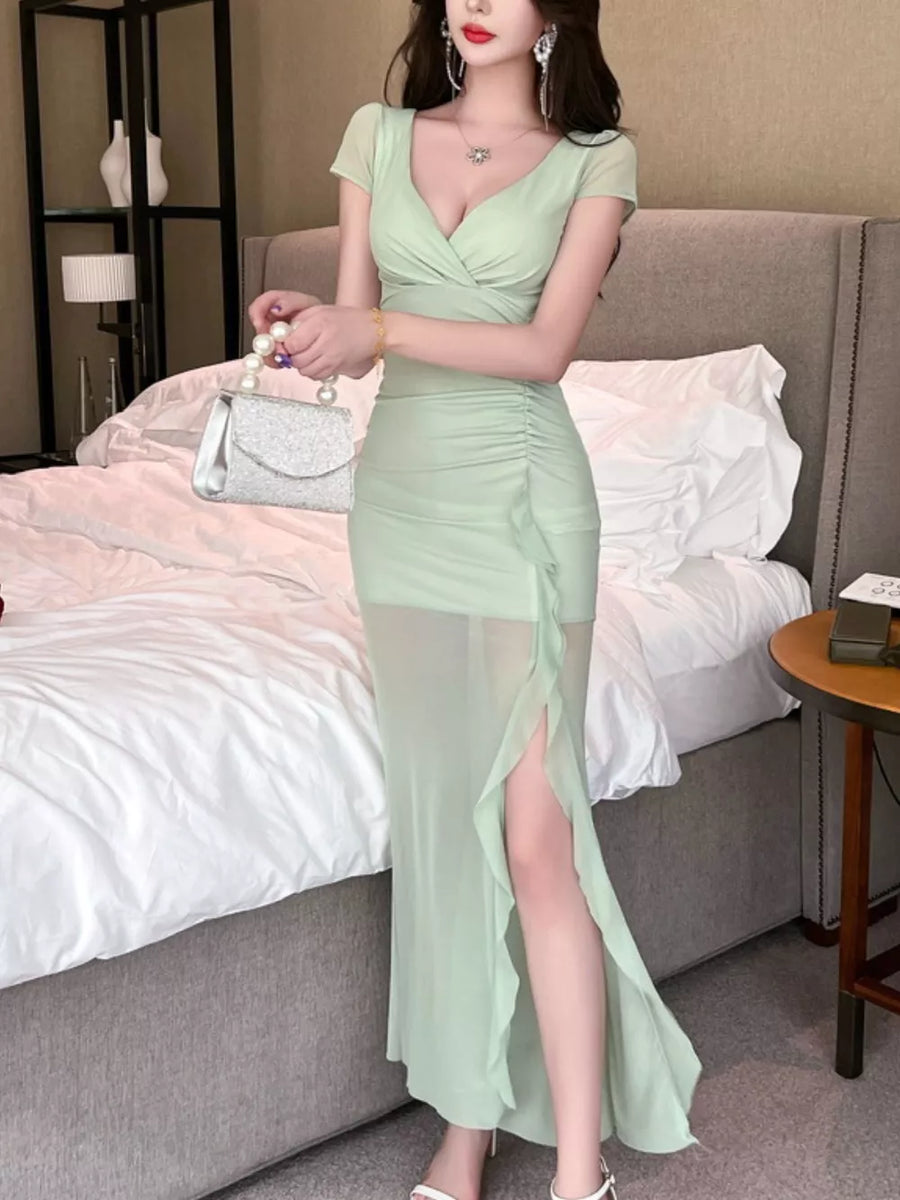 Light green surplice ruffle maxi dress with ruched detail and high slit.