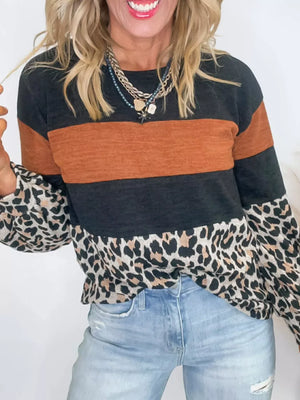 Leopard print patchwork blouse with black and rust stripes, long sleeves, and crew neck.