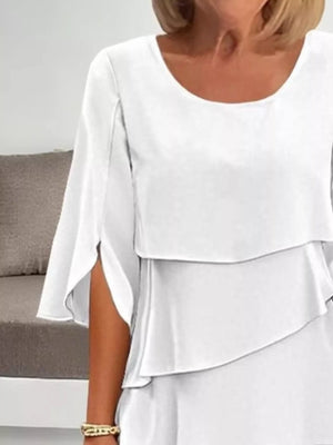 White ruffled layered dress with flutter sleeves and a scoop neck.