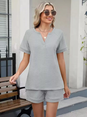 Light gray relaxed two-piece set with v-neck top and shorts, drawstring waist, pockets
