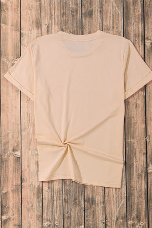 Tan t-shirt with rolled sleeves and a knotted hem detail.