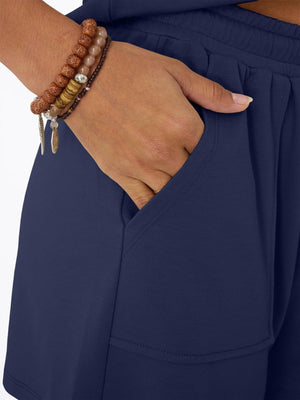 Navy drawstring shorts with pockets, part of a V-neck top and shorts set.