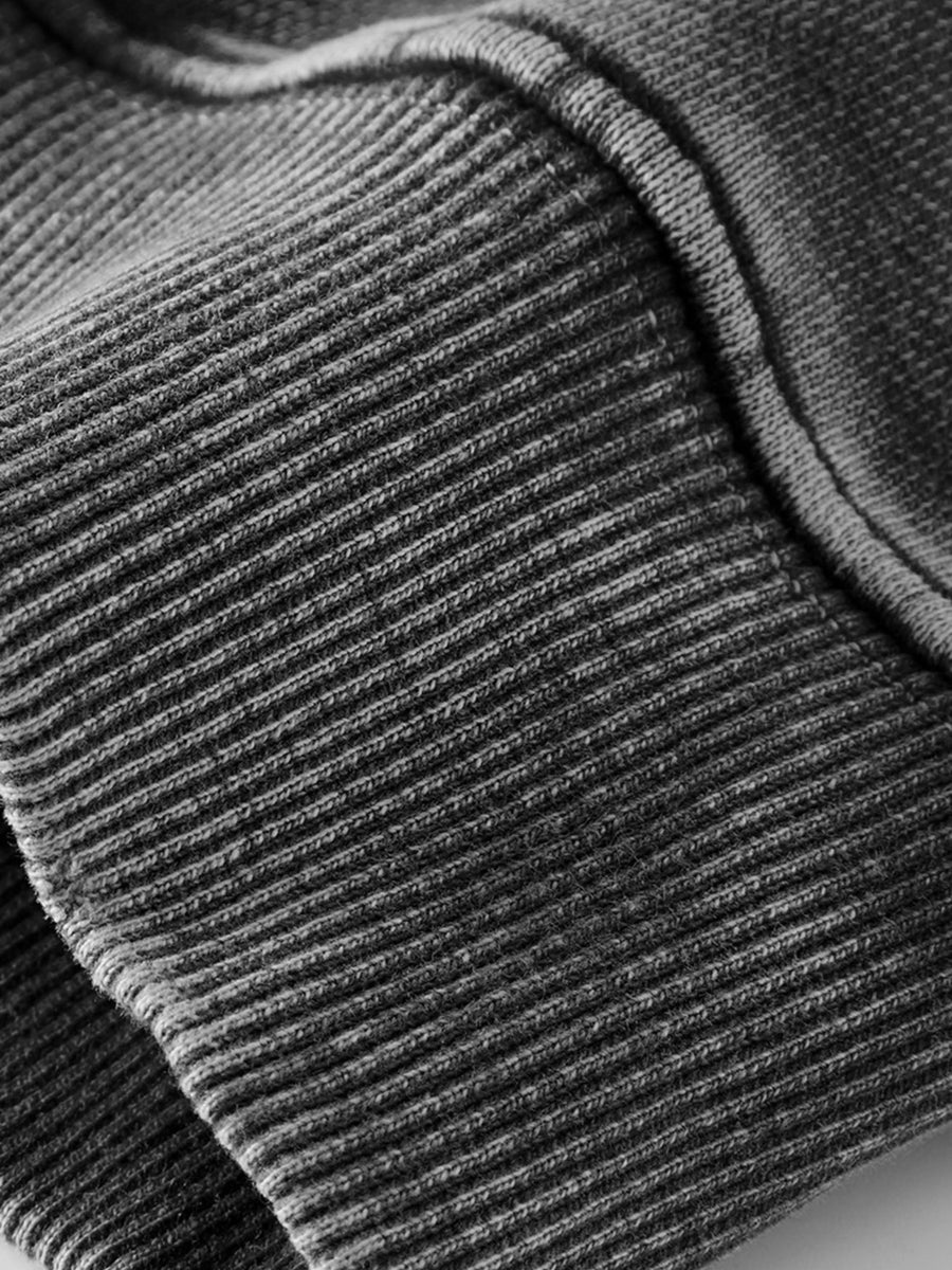 70% cotton, 30% polyester Care instructions: Machine wash cold pullover hoodie in charcoal with oversized silhouette