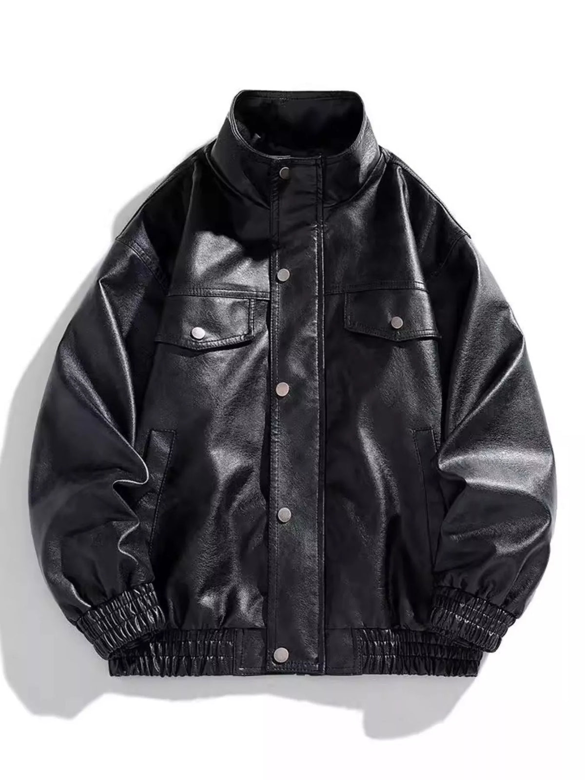 Black oversized faux leather bomber jacket with snap buttons and chest pockets.