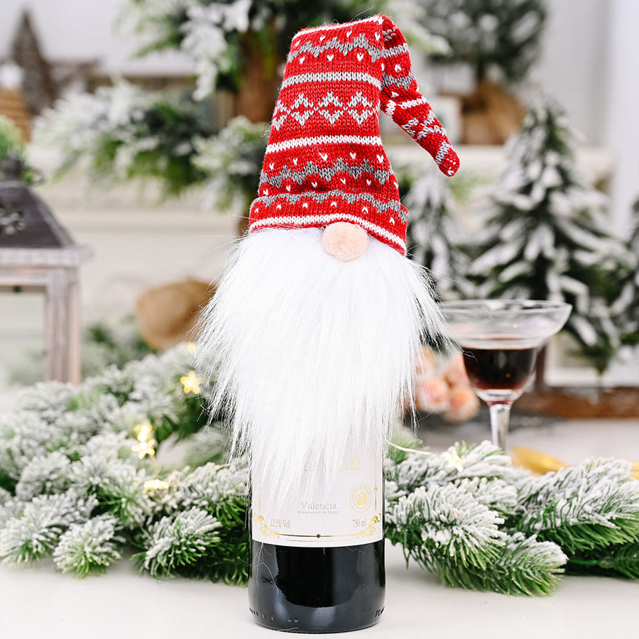 Festive gnome bottle topper in red knit hat with white beard, on wine bottle.