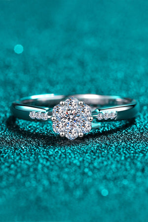 Silver engagement ring with floral cluster moissanite and accent stones.