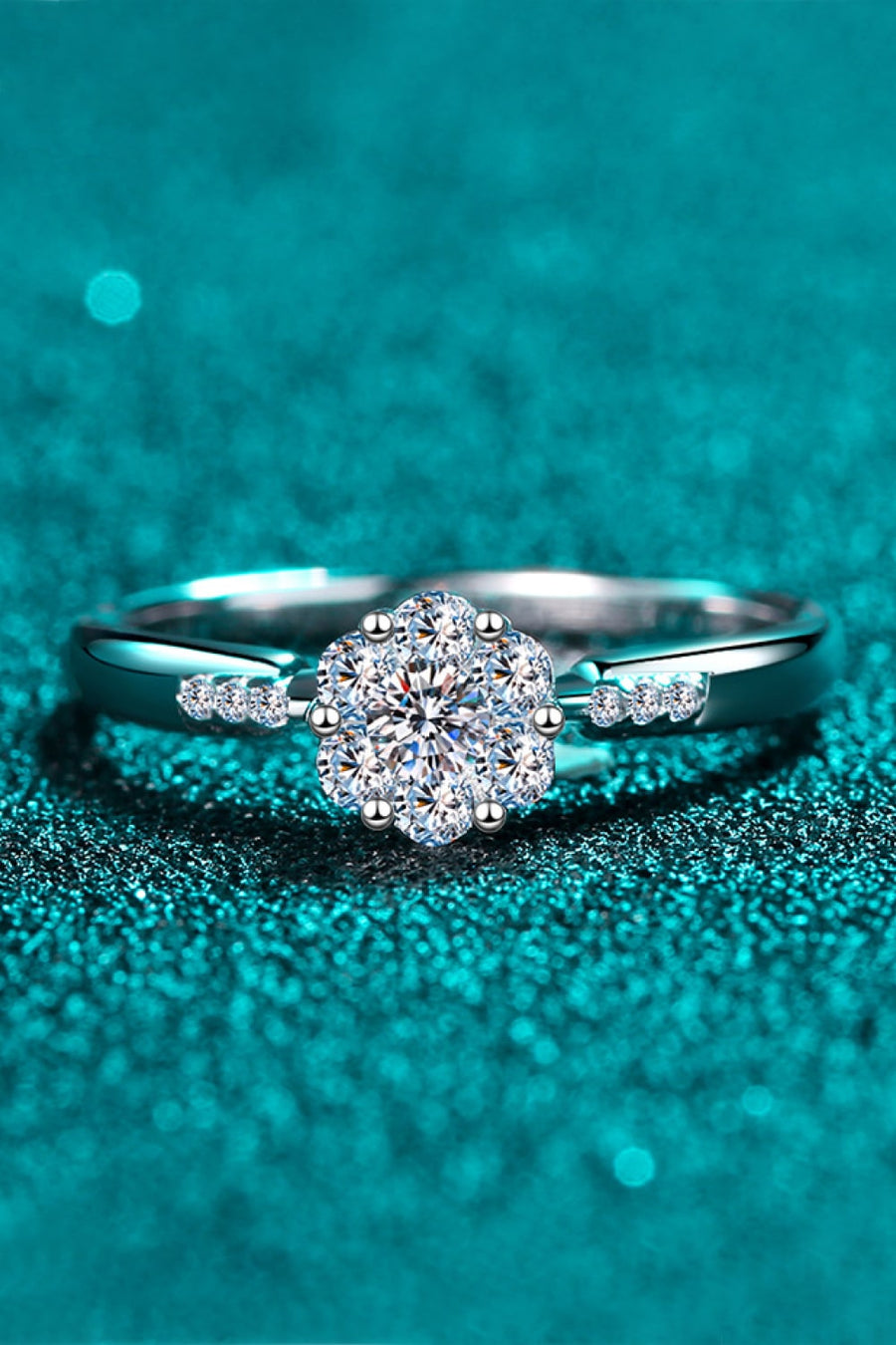 Silver engagement ring with floral cluster moissanite and accent stones.