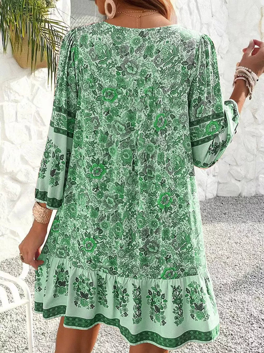 Matcha green floral print mini dress with tiered ruffle hem and long sleeves.