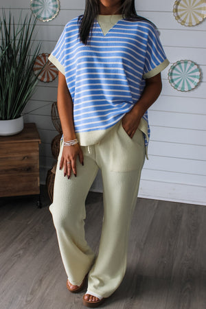 Relaxed fit striped t-shirt with blue and white stripes, short sleeves, and a V-neck.