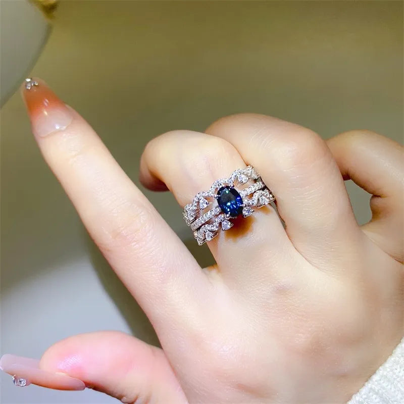 Silver sapphire and moissanite trio ring set with intricate detailing.