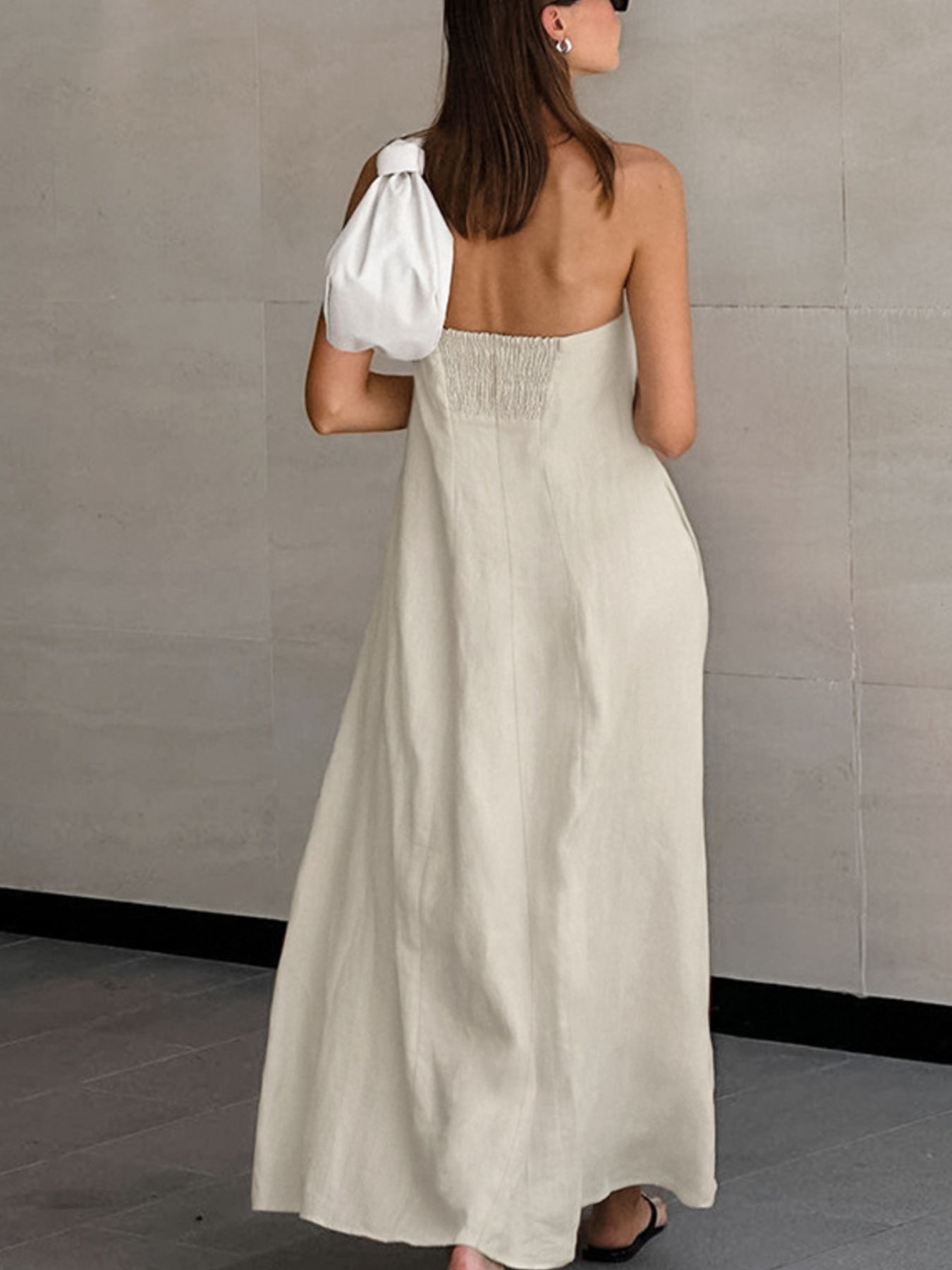 Beige cotton smocked tube dress with a-line cut and zipper detail.