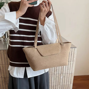 Sleek khaki suede flap tote bag with shoulder straps.