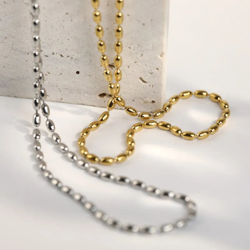 Dual-tone capsule chain necklace in gold and silver with oval bead links.