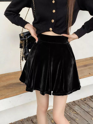 Black velvet A-line skort with pleats and a high waist.
