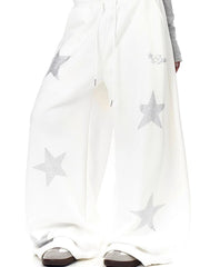 White wide leg sweatpants with all-over silver star embellishments and drawstring waist.
