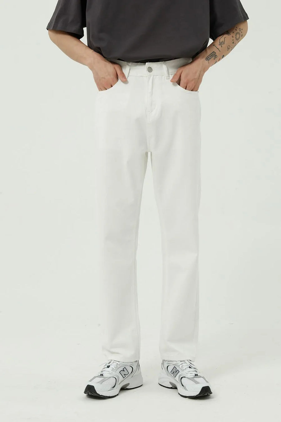 Relaxed fit ivory denim trousers with a straight leg and button fly.