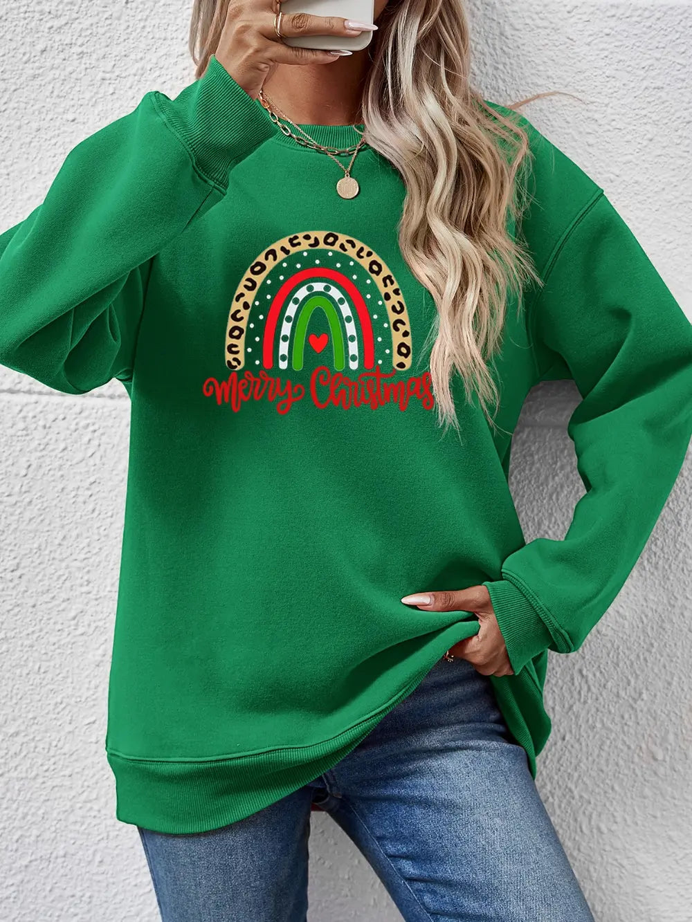Green Christmas sweatshirt with rainbow graphic and Merry Christmas text.