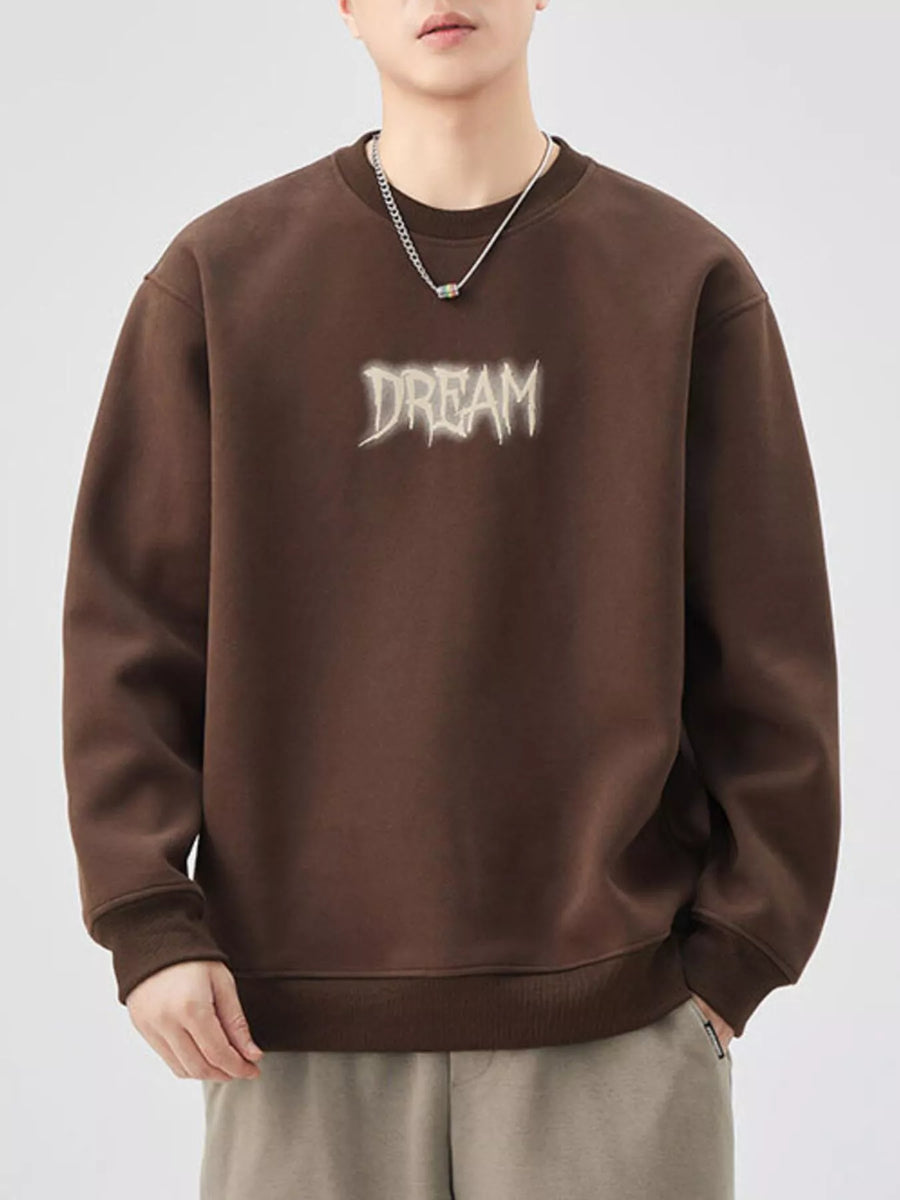 Brown crew-neck sweatshirt with "DREAM" graphic detail and ribbed cuffs and hem.