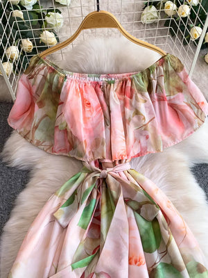 Botanical off-shoulder A-line dress in light pink with floral print and belted waist.