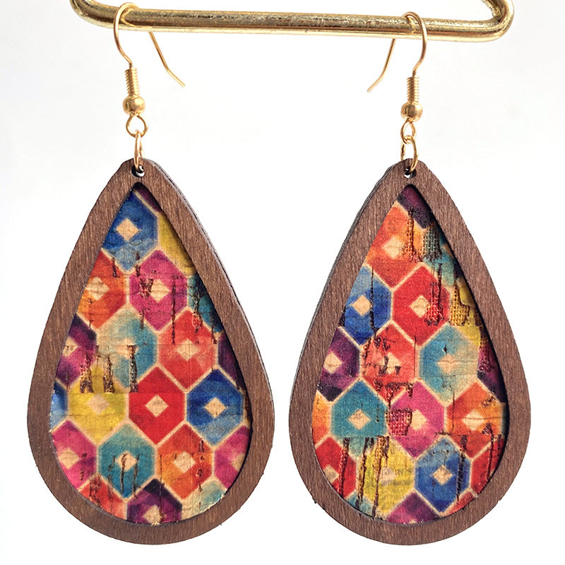 Teardrop cork earrings with geometric pattern in red, yellow, blue, and purple.