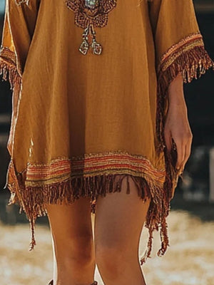 Embroidered bohemian mini dress in mustard yellow with fringe trim and colorful woven details.