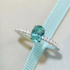 ring in teal featuring oval cut and fitted fit