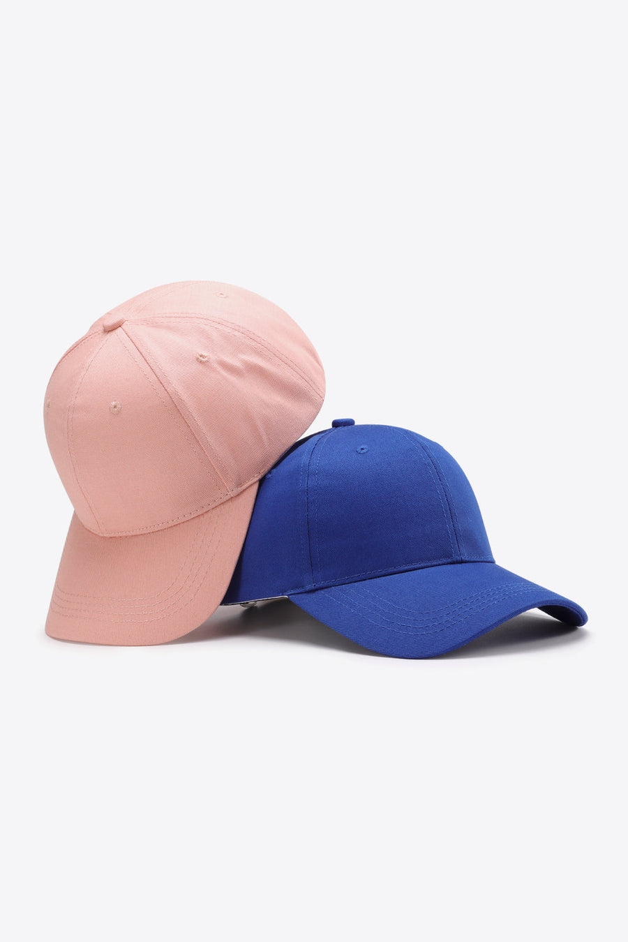 Blush pink and royal blue cotton twill baseball caps with adjustable strap