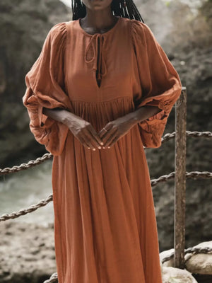 Amber tie-neck midi dress with puff sleeves and a keyhole cutout.