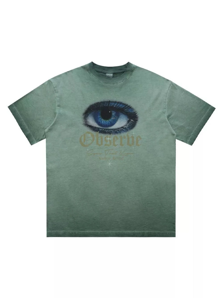 Green graphic t-shirt with an eye print and "Observe" text