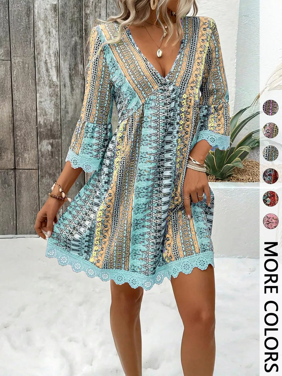 Bohemian printed V-neck dress with bell sleeves and lace trim in blue.