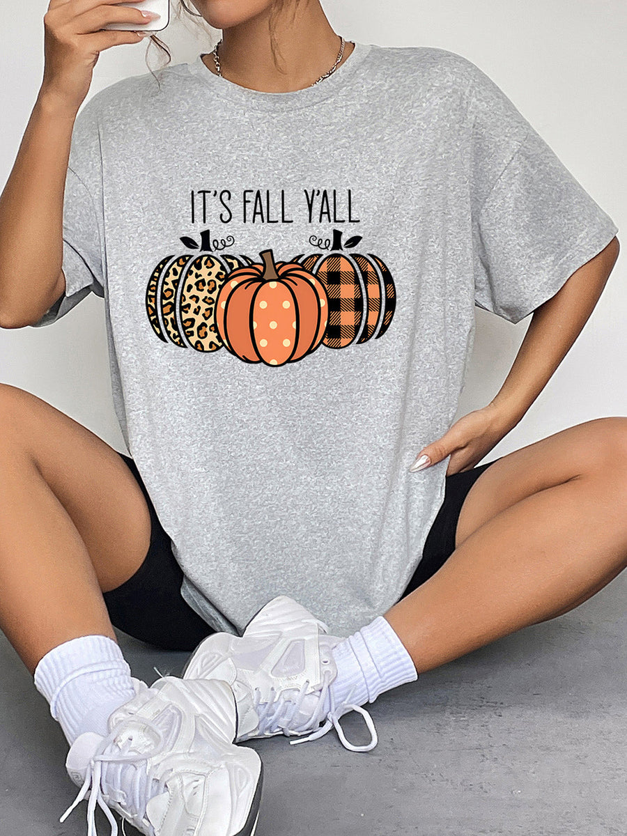 Gray graphic tee with "IT'S FALL Y'ALL" and three pumpkins: leopard print, polka dot, and plaid.