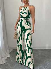 Elegant wide-leg jumpsuit in abstract green and cream pattern, halter neck, belted waist