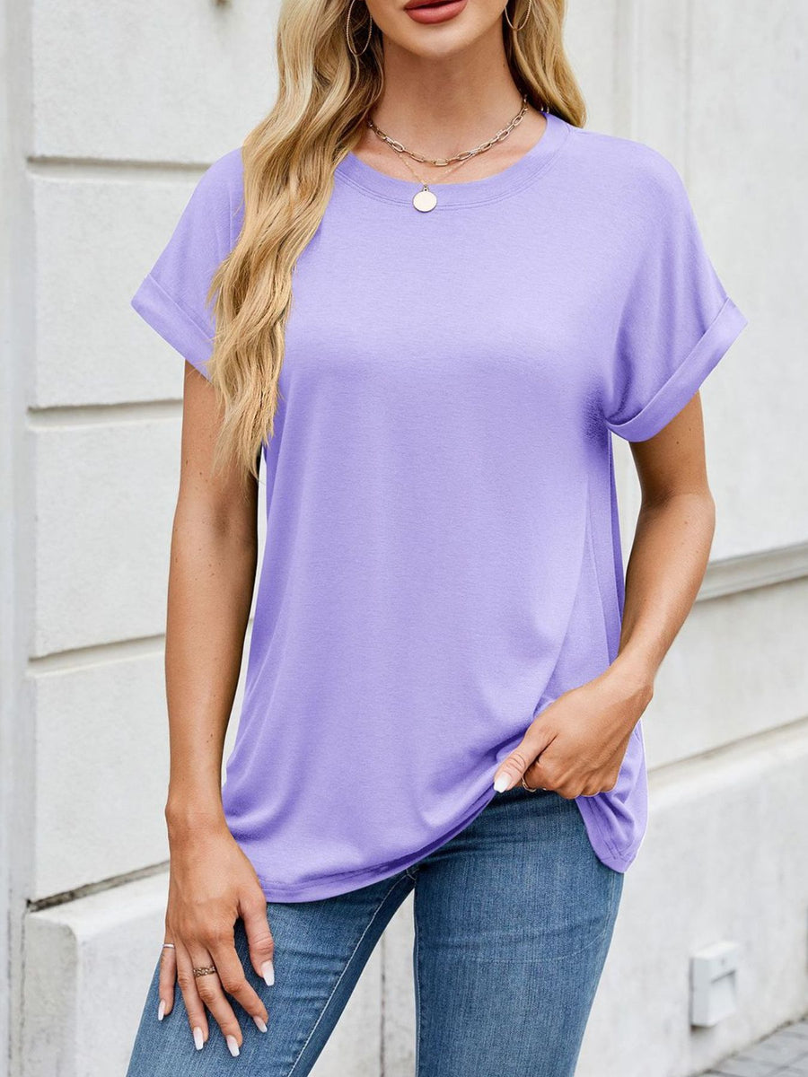 Basic lavender crew neck t-shirt with cuffed short sleeves, styled with jeans.