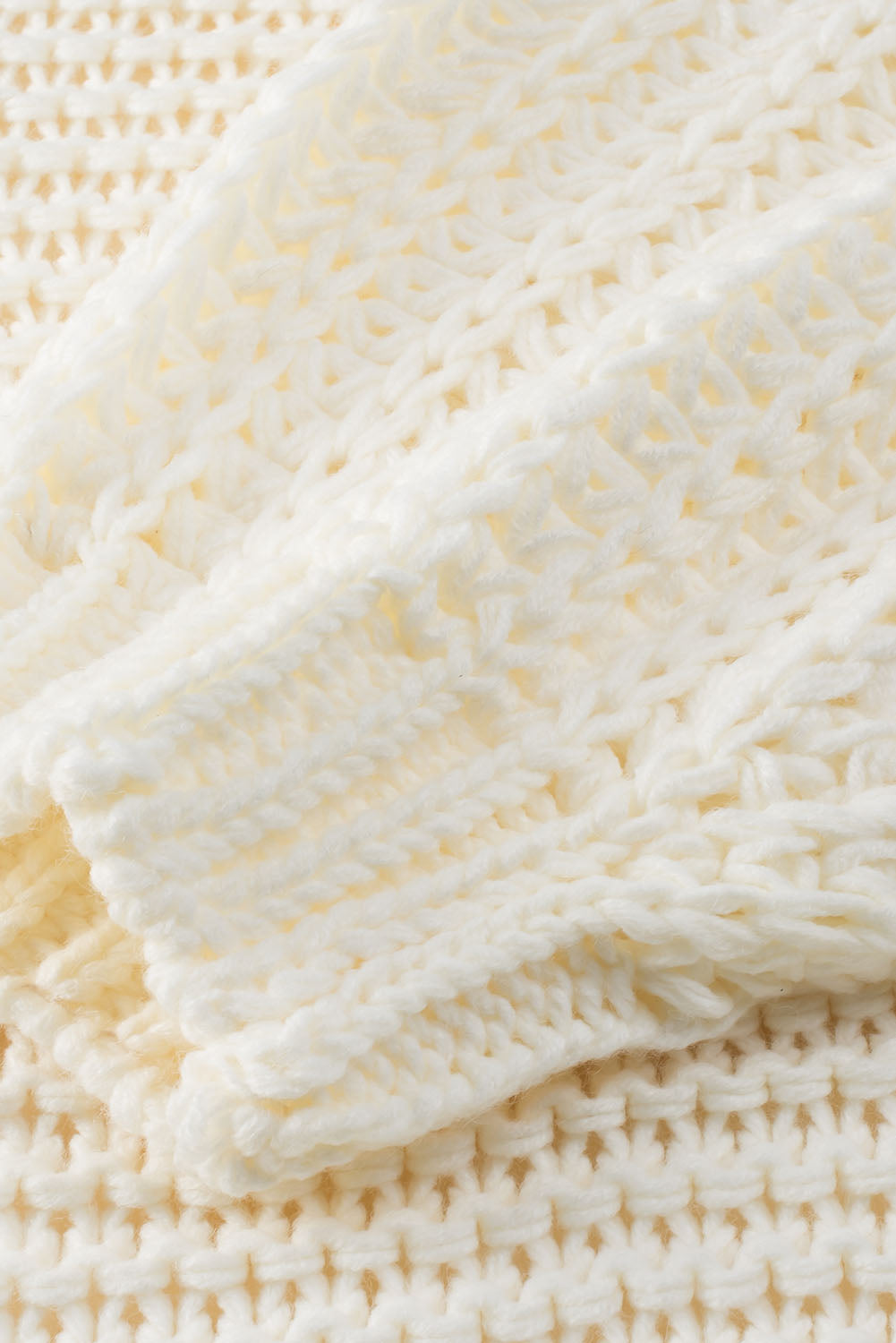 Textured knit cocoon cardigan in cream with a waffle knit pattern.