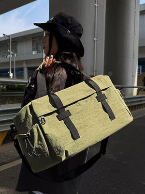 Spacious olive green duffel bag with black straps and adjustable shoulder strap.