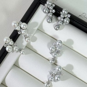 Sophisticated pearl and zircon cluster earrings in light gray and white.