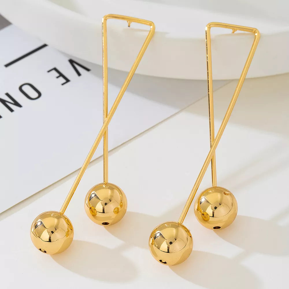 Gold earrings featuring drop design and geometric
