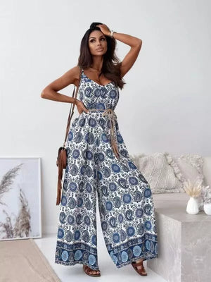 Paisley patterned white and blue wide-leg romper with tie belt and V-neck.