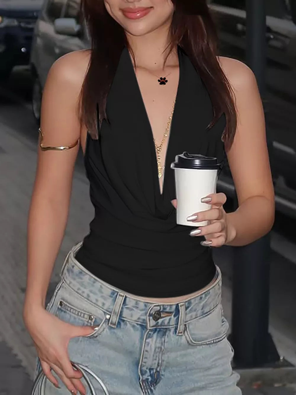 Black halter ruched cami top with deep V-neck, styled with jeans.