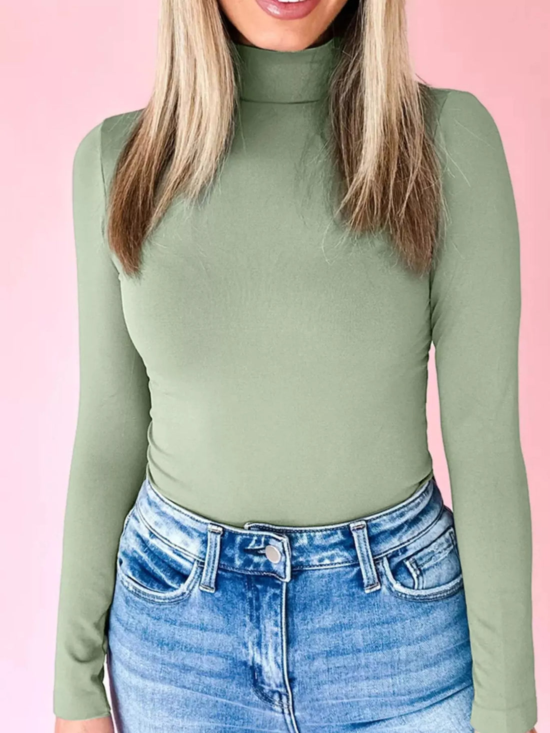 Sage stretchy long-sleeve turtleneck tunic with a high neckline.