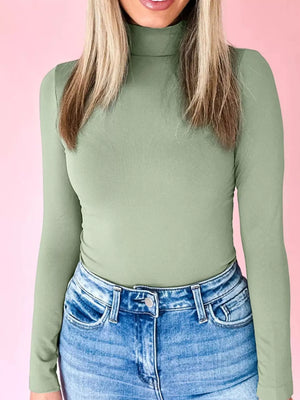 Sage stretchy long-sleeve turtleneck tunic with a high neckline.