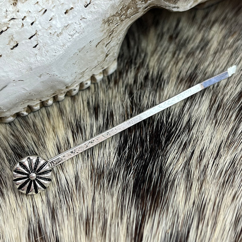 Silver alloy hair pin with a sunburst design and turquoise accent.