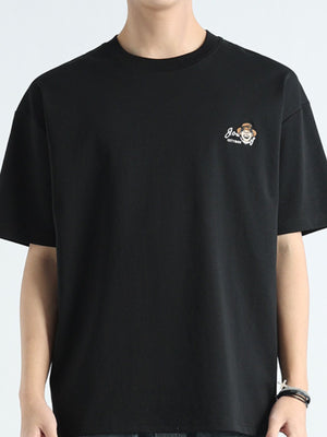 Men's black cotton t-shirt with round neck and embroidered graphic detail on chest.