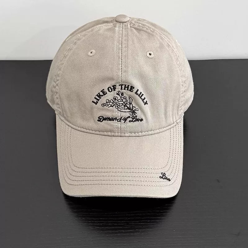 Khaki cotton cap with floral embroidery and text detail