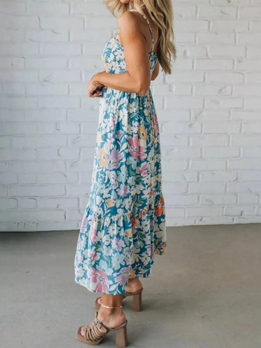 Maxi dress with floral print, spaghetti straps, tiered hem, and a flowy fit.